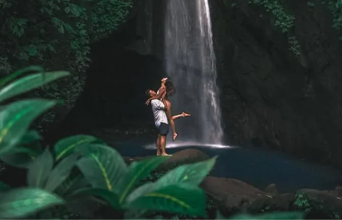 Couple enjoying Bali waterfall adventure